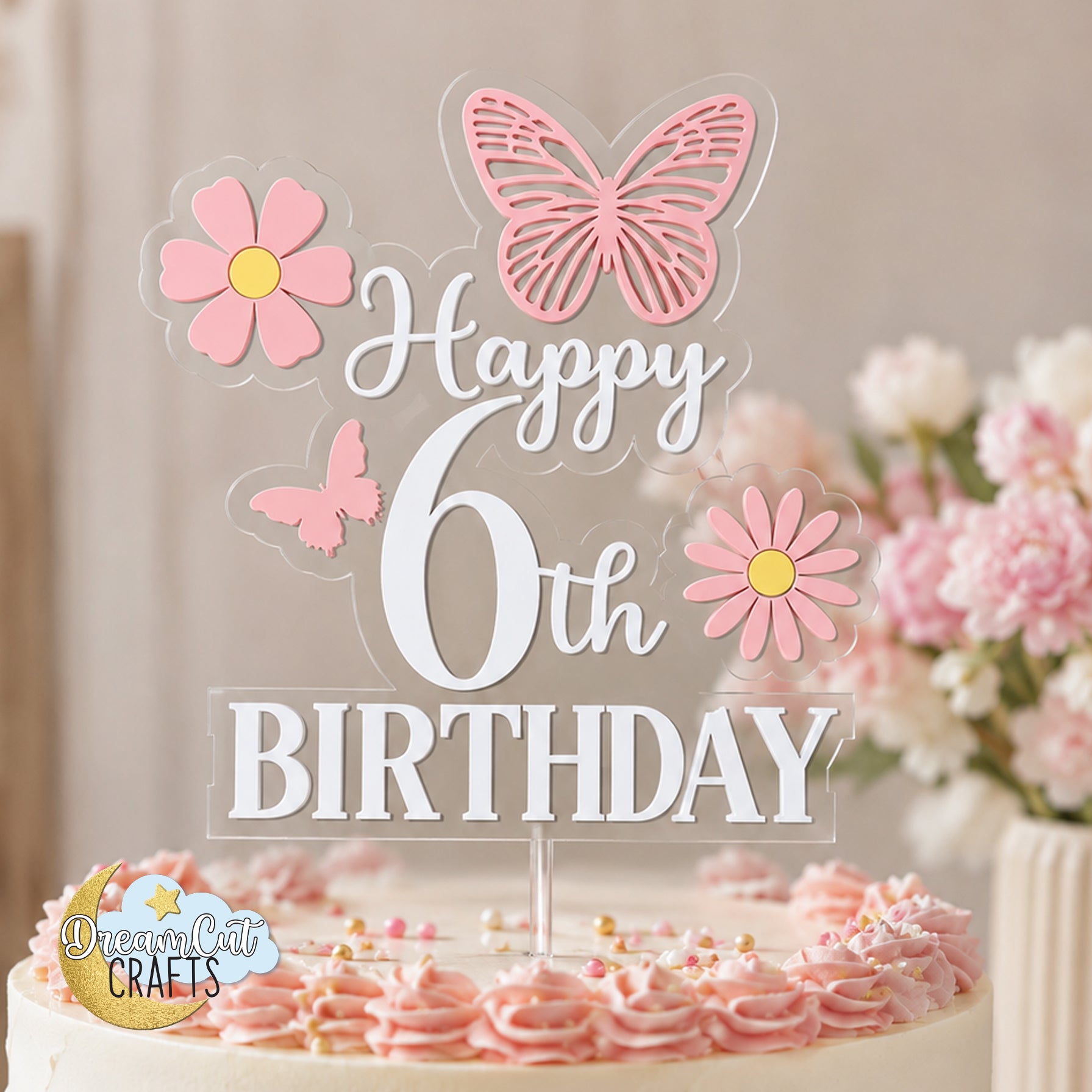 Layered acrylic birthday cake topper with custom age, white Happy Birthday lettering, pink butterflies and pink daisies attached to a clear acrylic base.