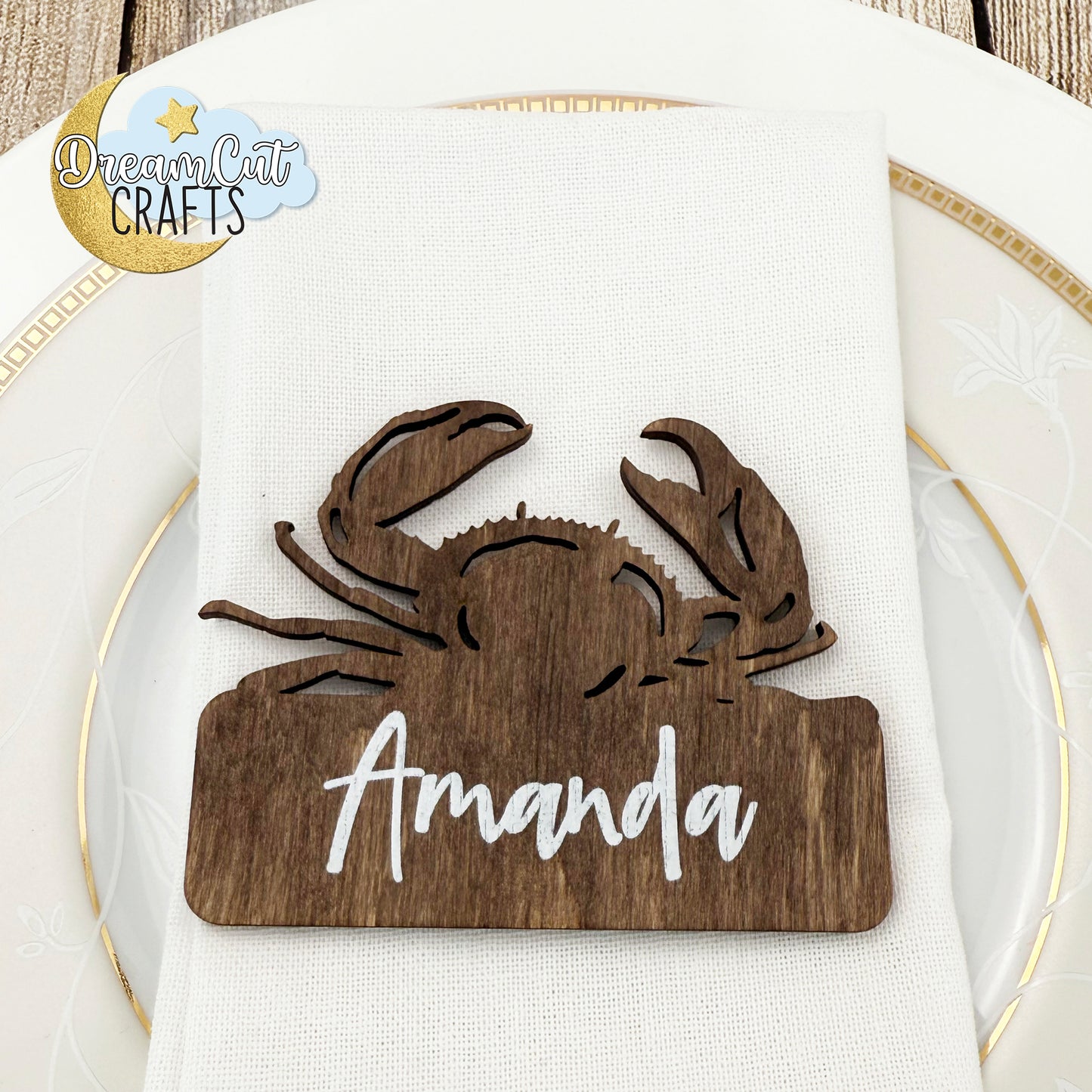 Wooden crab-shaped wedding place card with custom name.