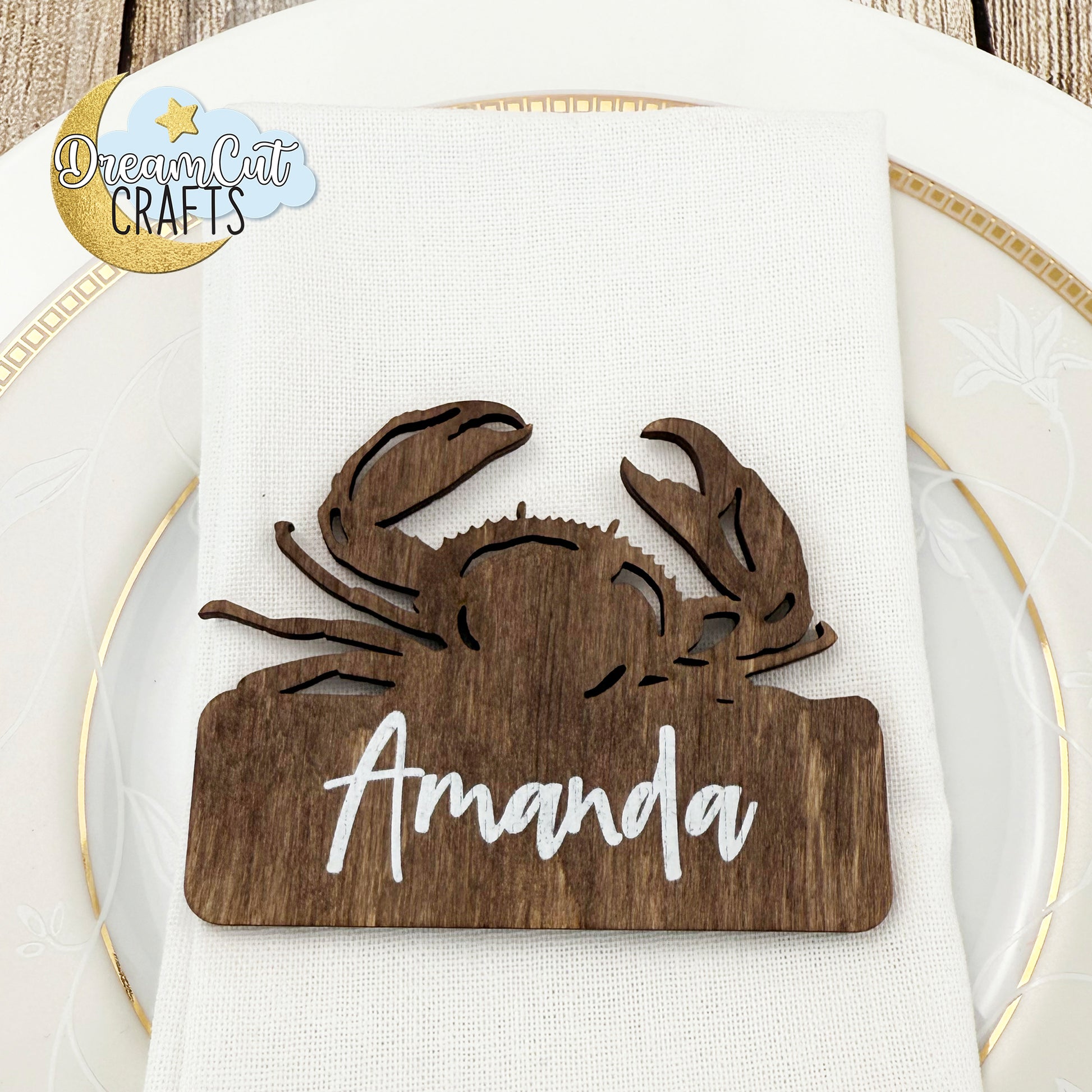 Wooden crab-shaped wedding place card with custom name.