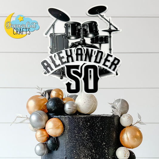 Custom layered drums cake topper with personalized name for music-themed birthday cake
