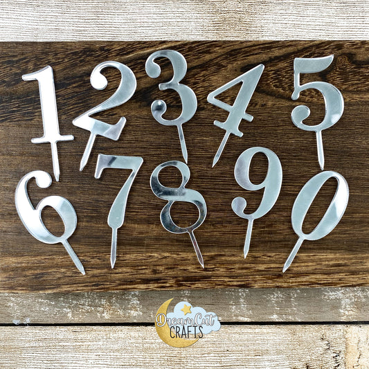Small acrylic cake topper numbers from 0 to 9 displayed in mirror finish for birthday and celebration cakes